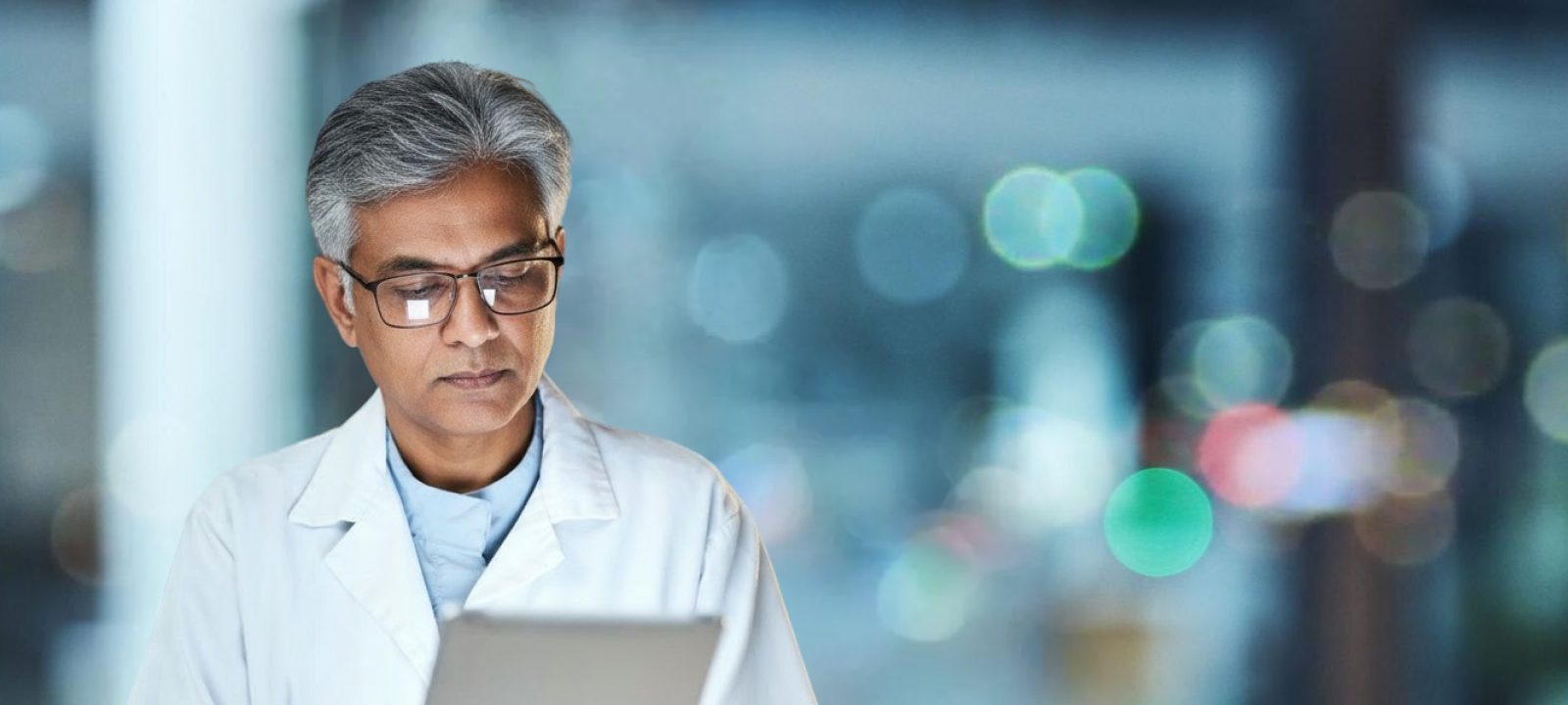 A healthcare professional reviewing information on a tablet
